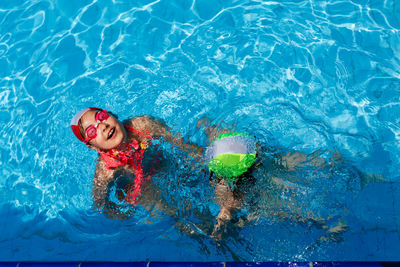 High angle view of woman swimming in pool