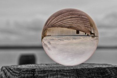 Close-up of crystal ball on wooden table