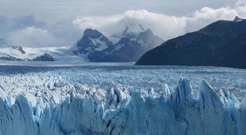 Panoramic view of snowcapped mountains against sky