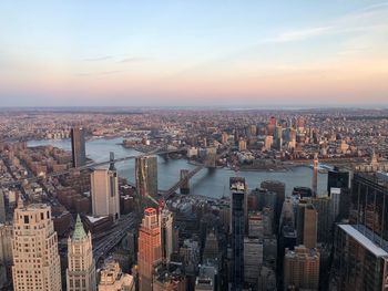 High angle view of city buildings against sky during sunset