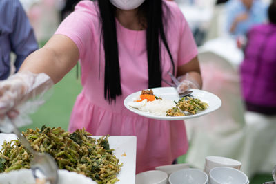 Midsection of woman having food