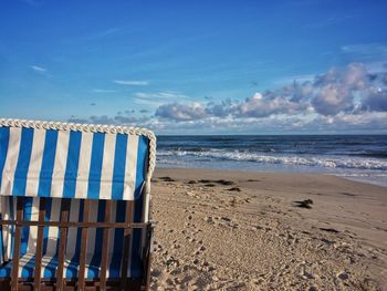 Scenic view of beach against blue sky