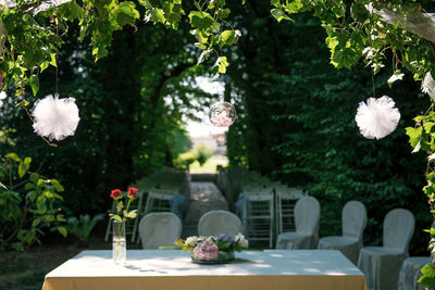 White flower vase on table in yard