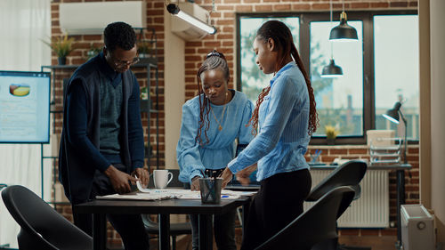 Side view of business colleagues working at office