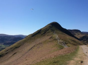 Scenic view of mountains against clear blue sky