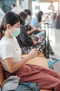 Midsection of woman using mobile phone