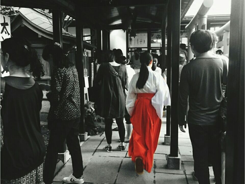 REAR VIEW OF PEOPLE WALKING IN CORRIDOR OF BUILDING