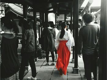 Rear view of people walking in corridor