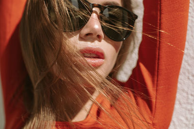 Close-up portrait of young woman wearing sunglasses