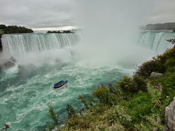 Scenic view of waterfall in sea