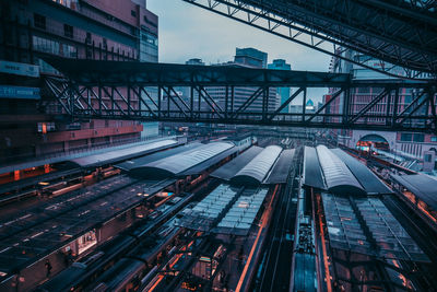 Railroad tracks in city against sky