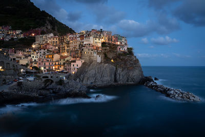 Scenic view of sea and buildings against sky