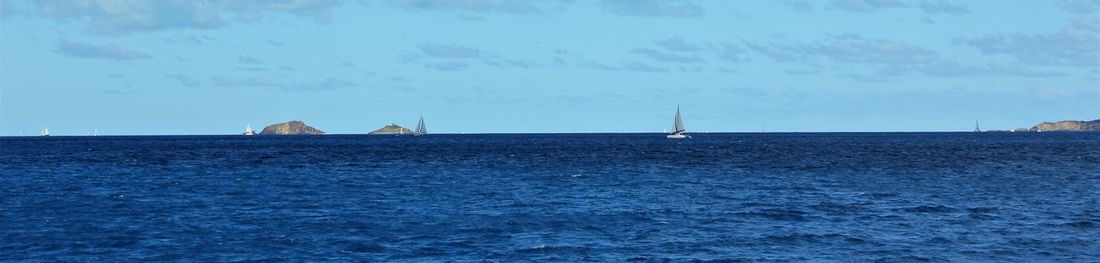 Scenic view of sea against blue sky