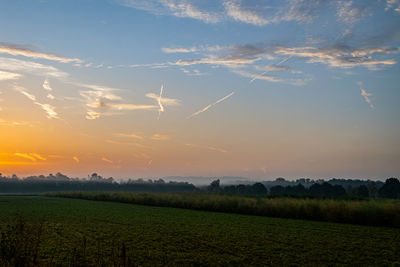 Scenic view of field against sky during sunset