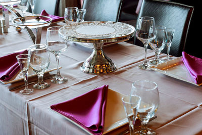 High angle view of wineglasses and plates on table in restaurant