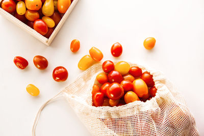 High angle view of tomatoes on table against white background