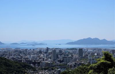 City by sea against clear sky