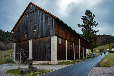 Road by building against sky