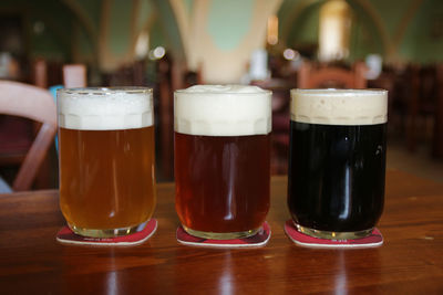 Close-up of beer in glasses on table