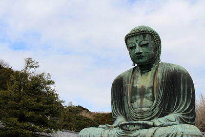 Low angle view of statue against sky