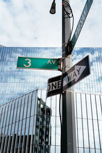 Low angle view of road sign against sky