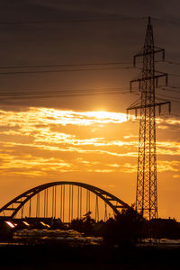 Silhouette bridge against sky during sunset