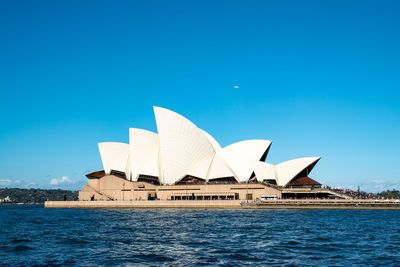 Buildings in city against blue sky