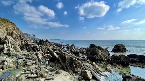 Rocks on beach against sky