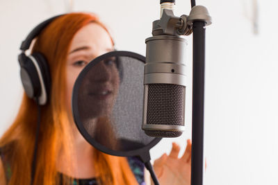 Close-up of singer singing song at studio