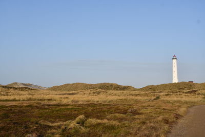 Lighthouse on land against clear sky