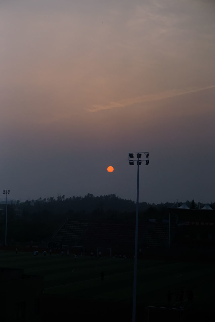 sunset, sky, orange color, beauty in nature, scenics - nature, sun, nature, no people, field, tranquil scene, cloud - sky, land, street, tranquility, lighting equipment, street light, silhouette, outdoors, landscape, idyllic