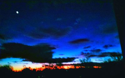 Low angle view of landscape against cloudy sky