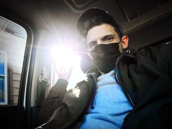 Portrait of young man sitting in bus