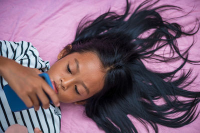 Close-up portrait of woman lying on bed