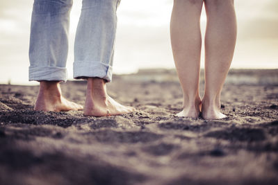 Low section of people standing at beach