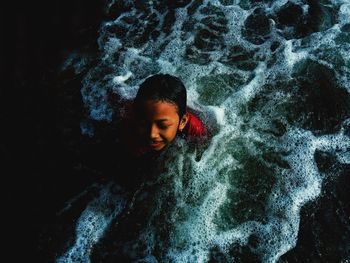 High angle portrait of boy in sea