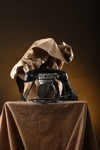 Close-up of hat sitting on table against black background