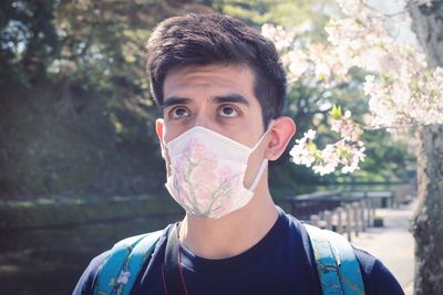 Portrait of young man against trees