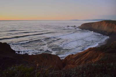 Scenic view of sea against clear sky during sunset