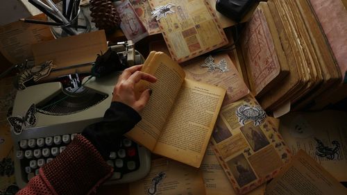 High angle view of man reading book on table