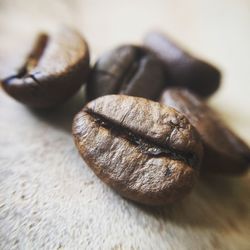 Close-up of roasted coffee beans on table