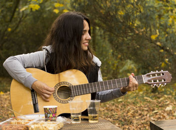 Young woman playing guitar