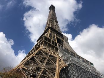 Low angle view of tower against cloudy sky