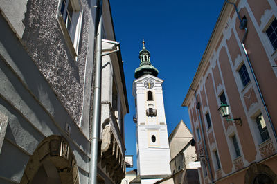 Low angle view of buildings against clear blue sky