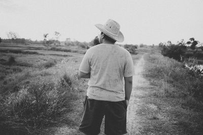 Rear view of man standing on field