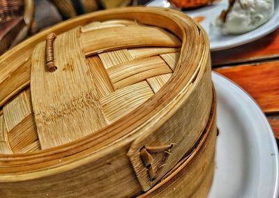 Close-up of wicker container on table