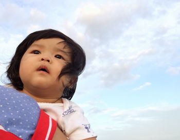 Portrait of cute baby girl against sky