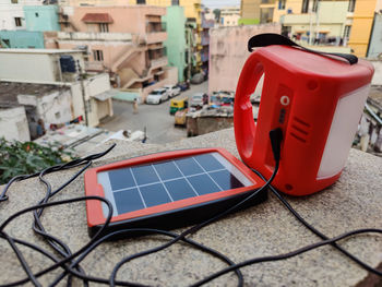 Picture of small size red color solar panel with torch or solar lamp for renewable and clean energy. 