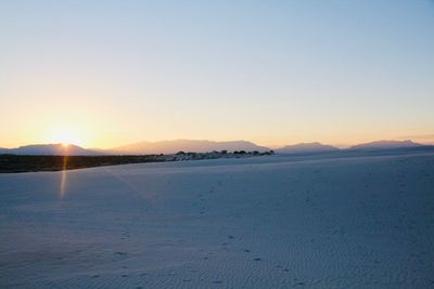 Scenic view of sea against clear sky during sunset