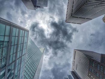 Low angle view of modern building against cloudy sky
